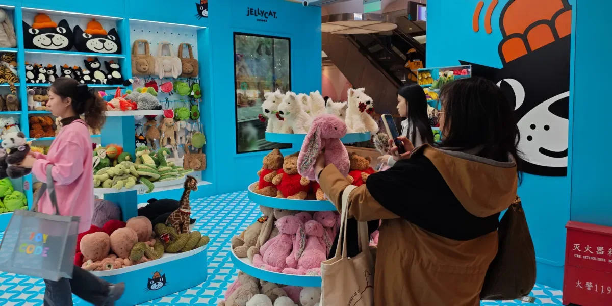 Gen Z consumer takes picture of Jellycat in store.