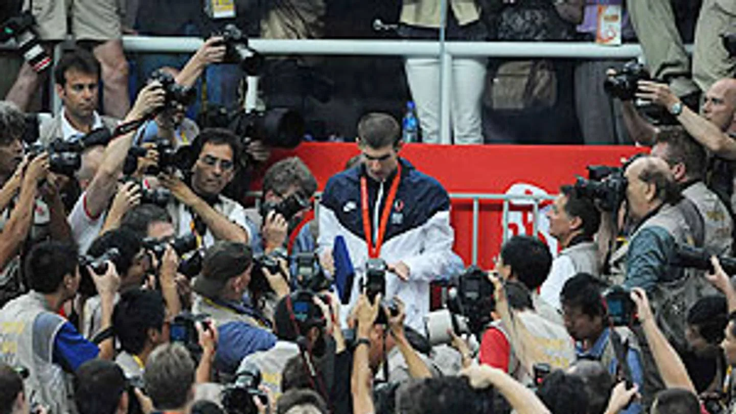 Phelps with his medals, surrounded by photographers in Beijing