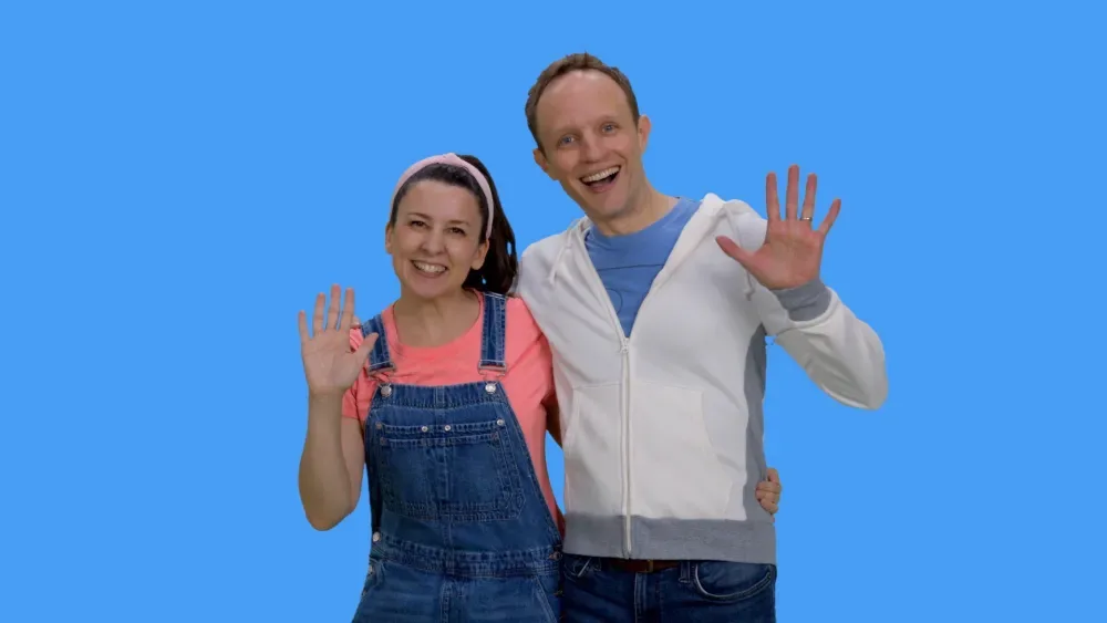 Ms Rachel and a co-star waving in Songs for Littles