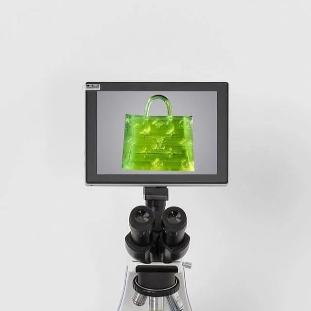 MSCHF on Instagram: "Microscopic Handbag by MSCHF🔬 Smaller than a grain of sea salt and narrow enough to pass through the eye of a needle, this is a purse so small you'll need a microscope to see…