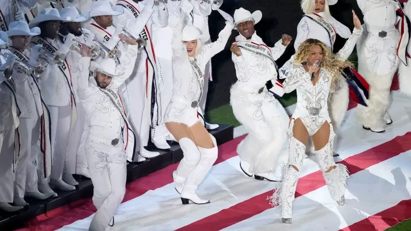 Beyoncé and performers in white on the field in Houston