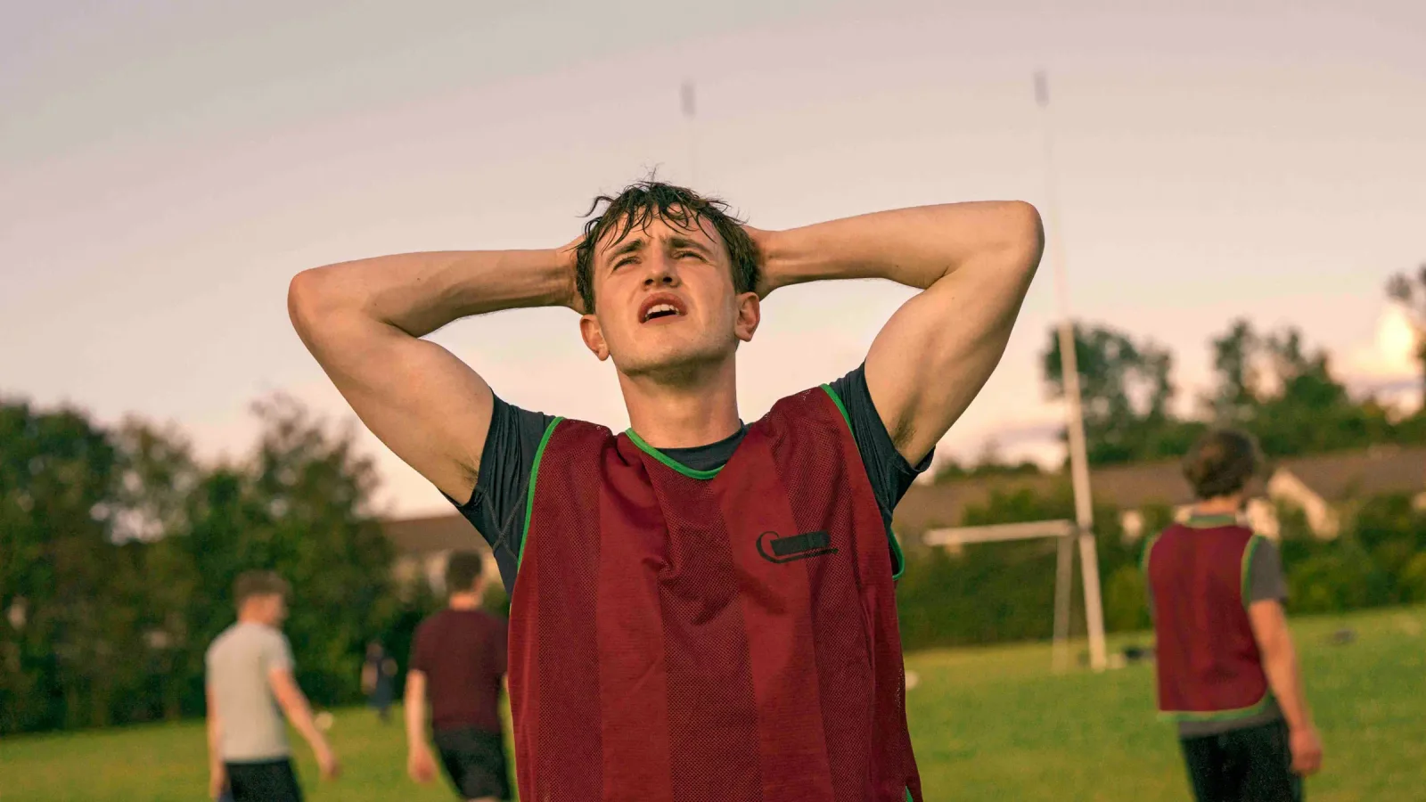 Connell with his hands on his head on a football pitch