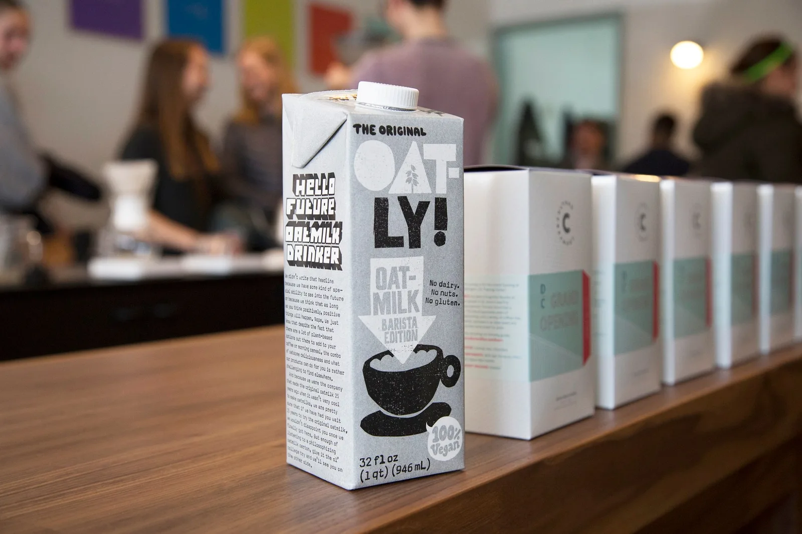 Oatly Barista Edition cartons lined up on a café bar