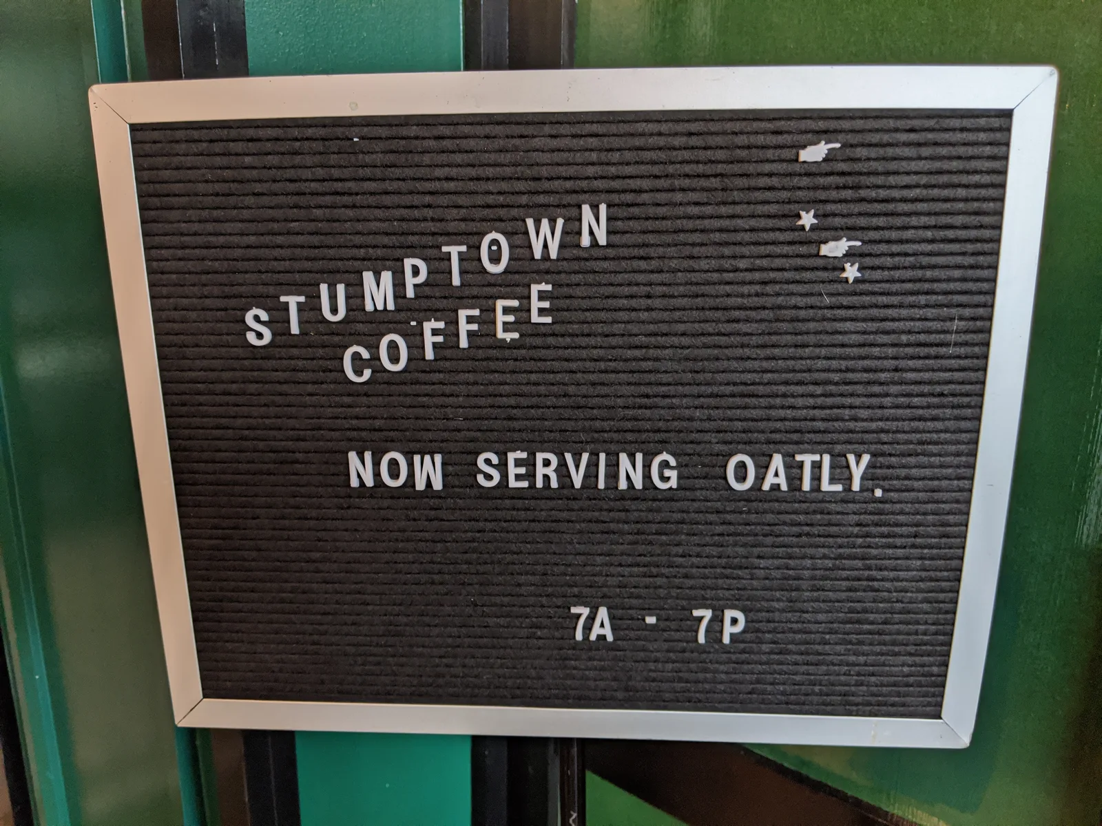 A café sign announcing it now serves Oatly