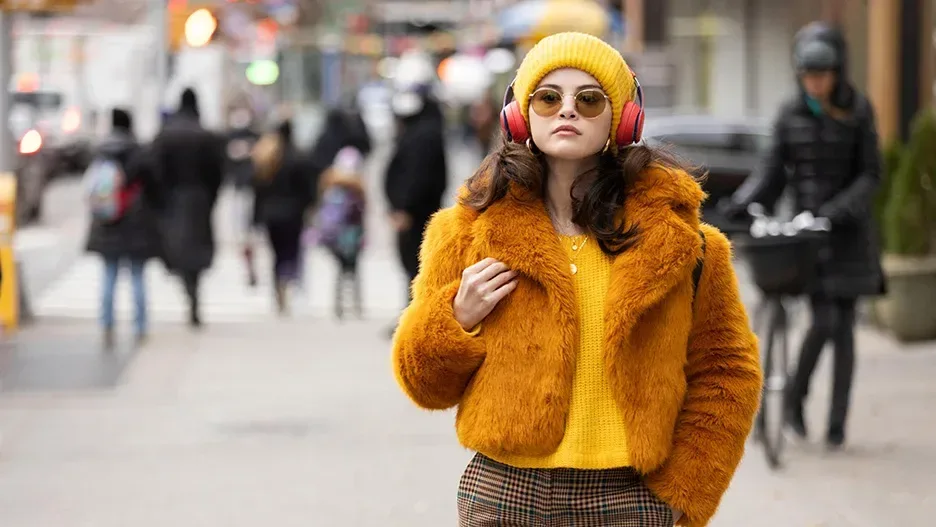 Selena Gomez as Mabel in her yellow coat.
