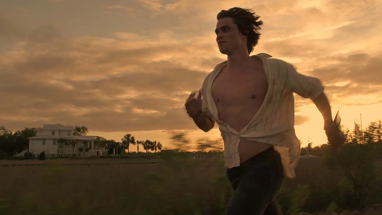 John B running through marsh grass at sunset.