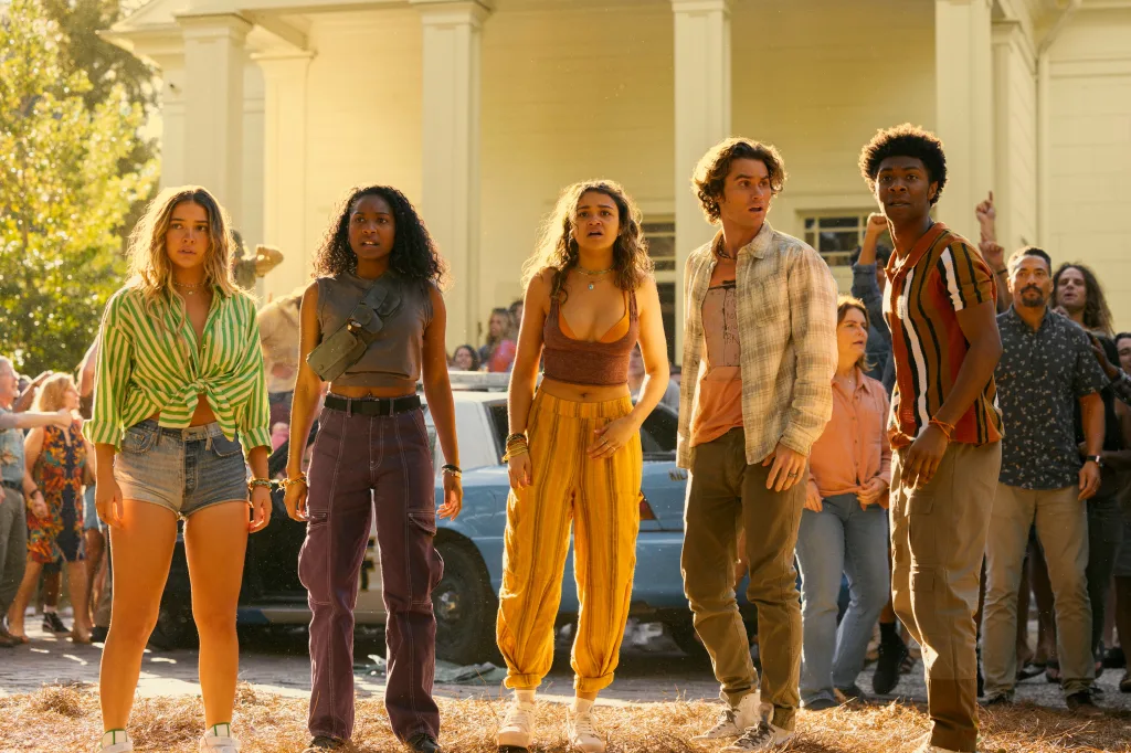 The cast walking together in a scene from Outer Banks.