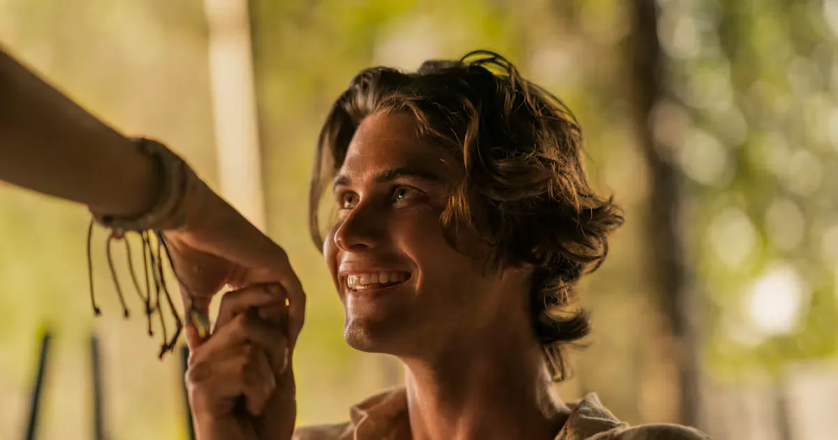 John B smiling in a scene from Outer Banks.