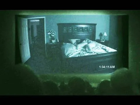 Trailer frame: a night-vision audience watching the film