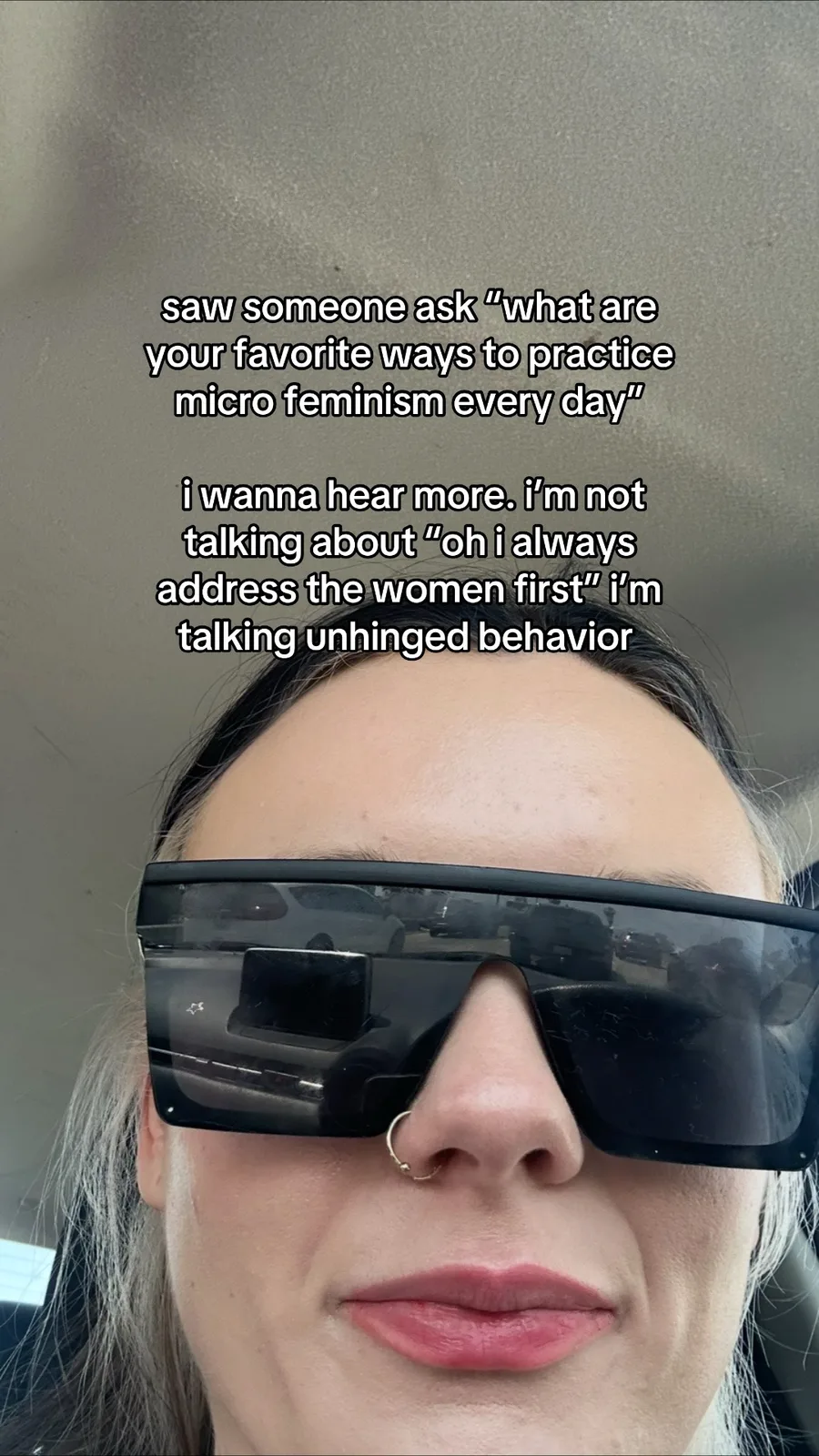 Original microfeminism prompt over a selfie of a person wearing sunglasses; image supplied by TikTok’s official embed.