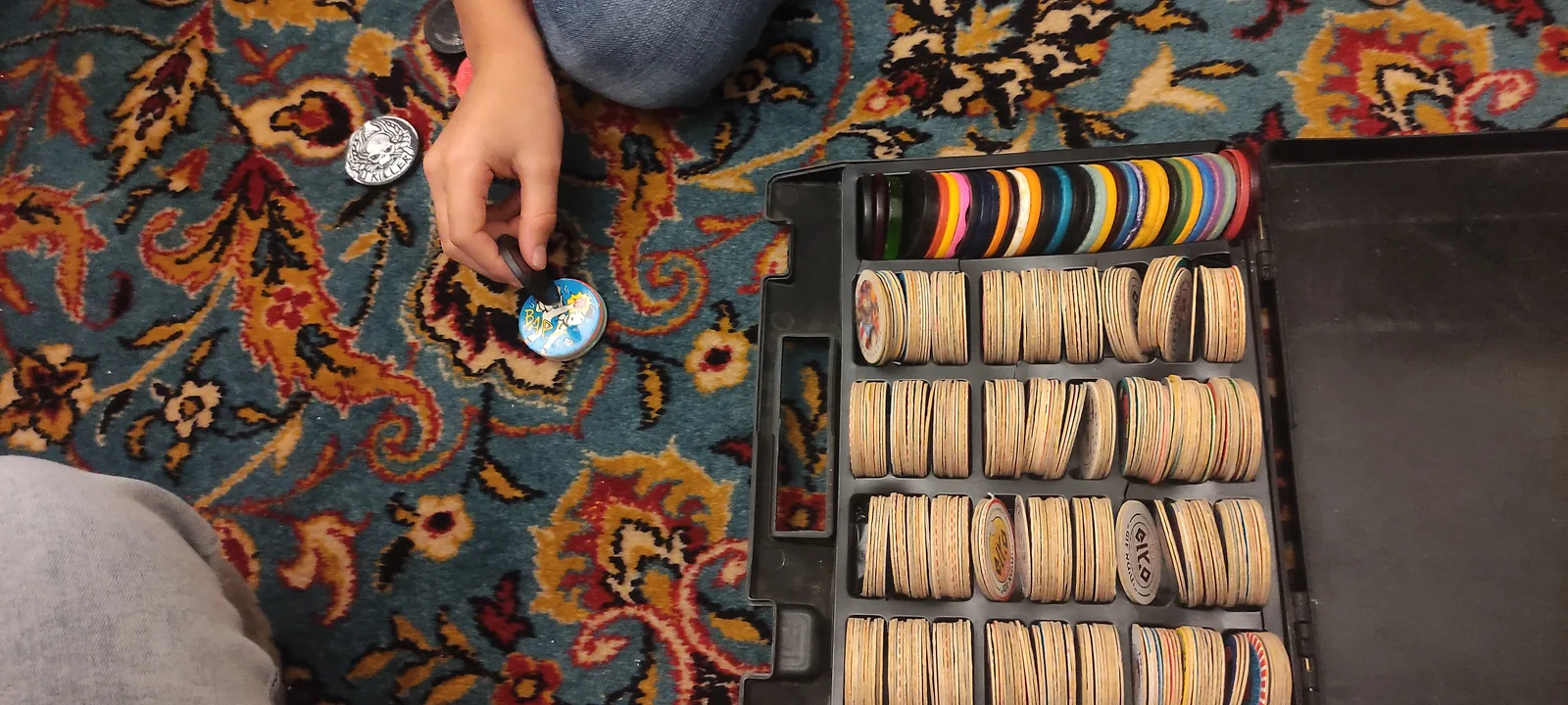 Israeli pog collection and playing case, photographed in 2023. CC BY 4.0.