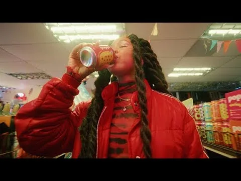 A woman drinking Poppi in its Super Bowl LVIII 2024 commercial