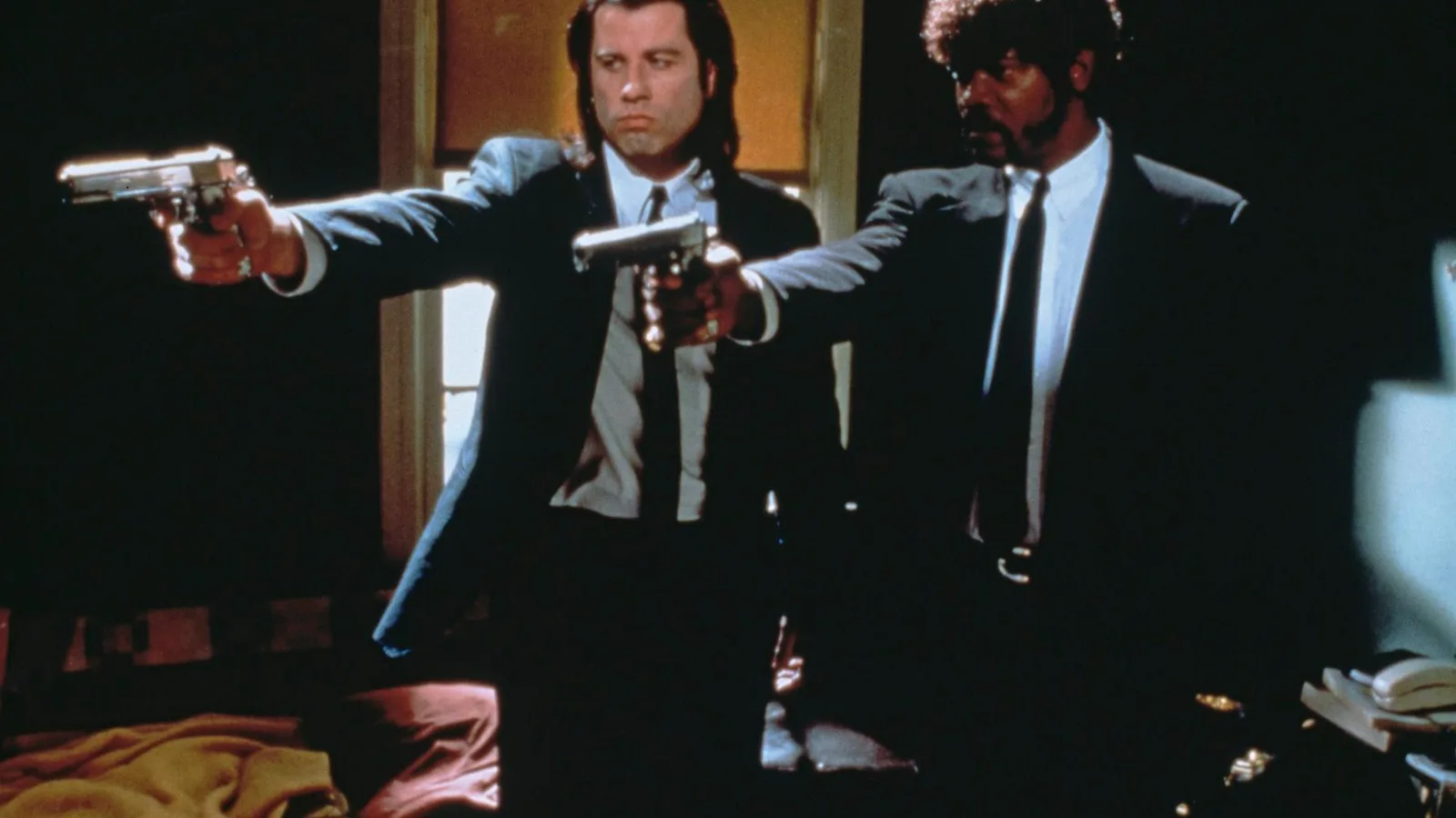 Vincent and Jules aim their guns in Pulp Fiction
