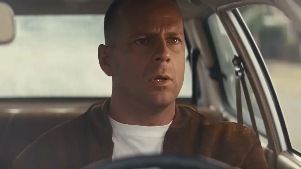 Bruce Willis as Butch, driving, in the official trailer
