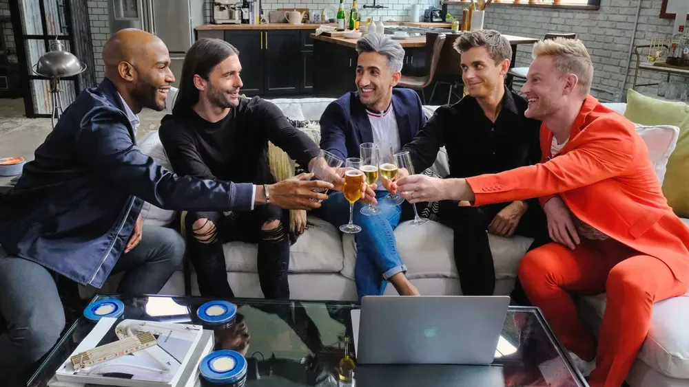 The Fab Five toast with a makeover hero