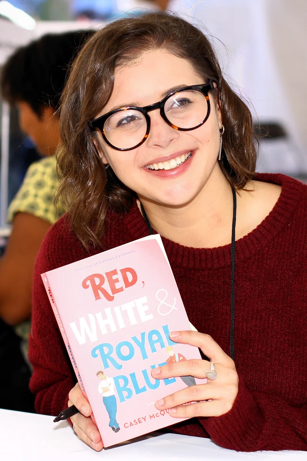 Casey McQuiston holding the novel at the 2019 Texas Book Festival