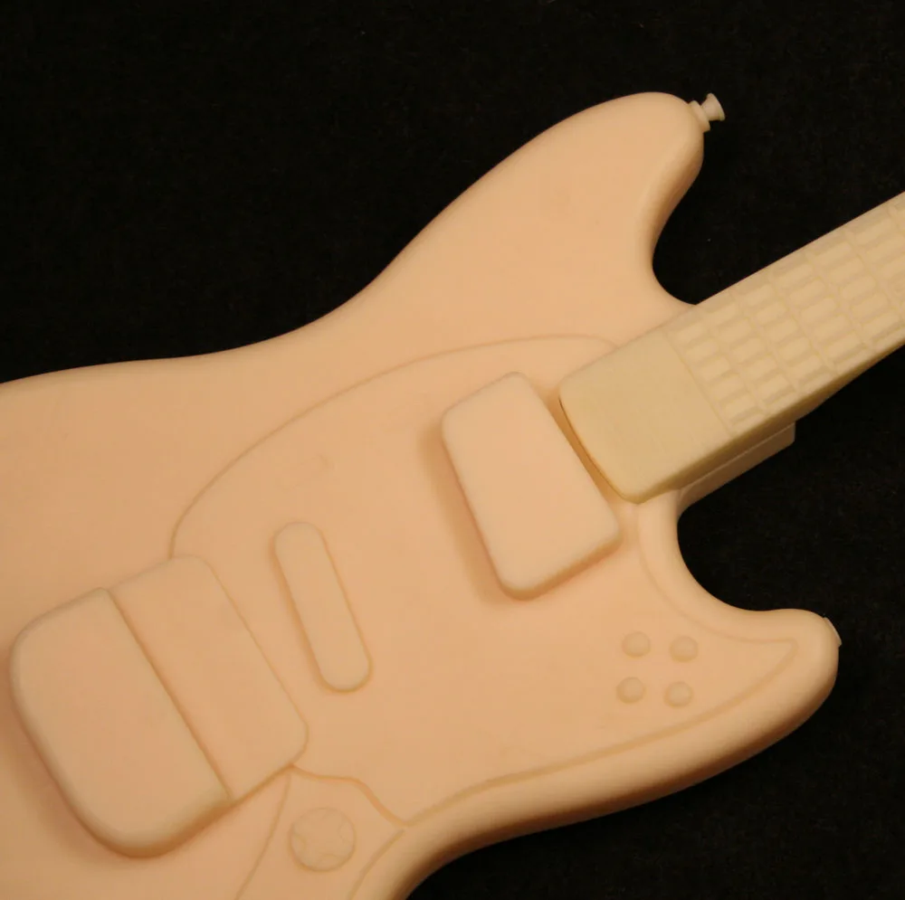 Owner's retrospective with original guitar and drum prototypes and photos of launch bundles.