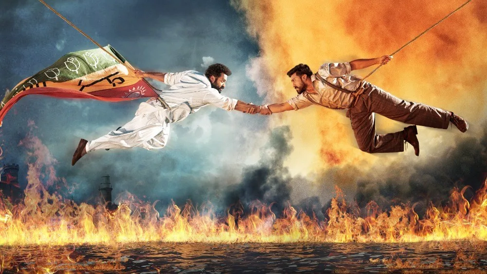 Ram and Bheem reaching for each other across fire and water in RRR.