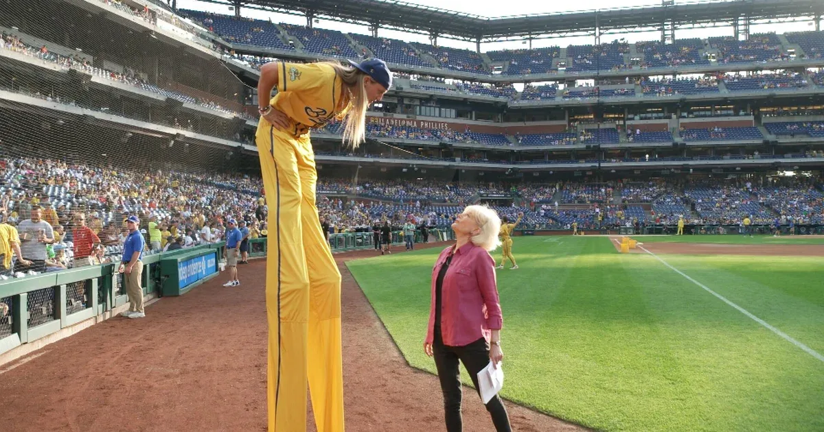A Bananas player on stilts in a major-league stadium