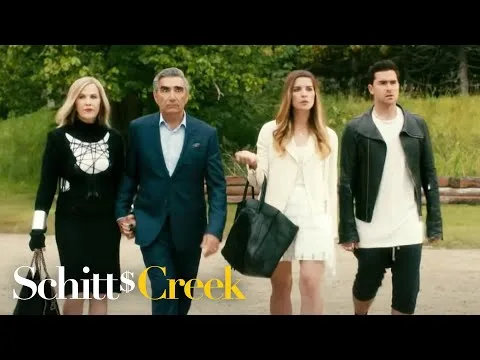 The Rose family walking, with the Schitt's Creek title.