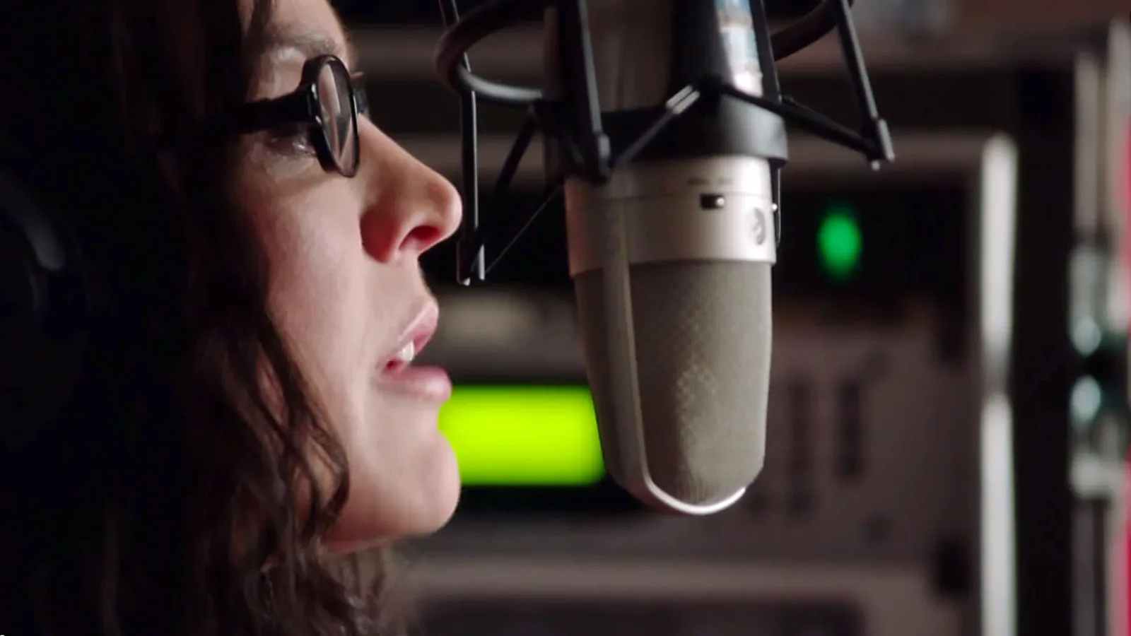 Sarah Koenig at a studio microphone.