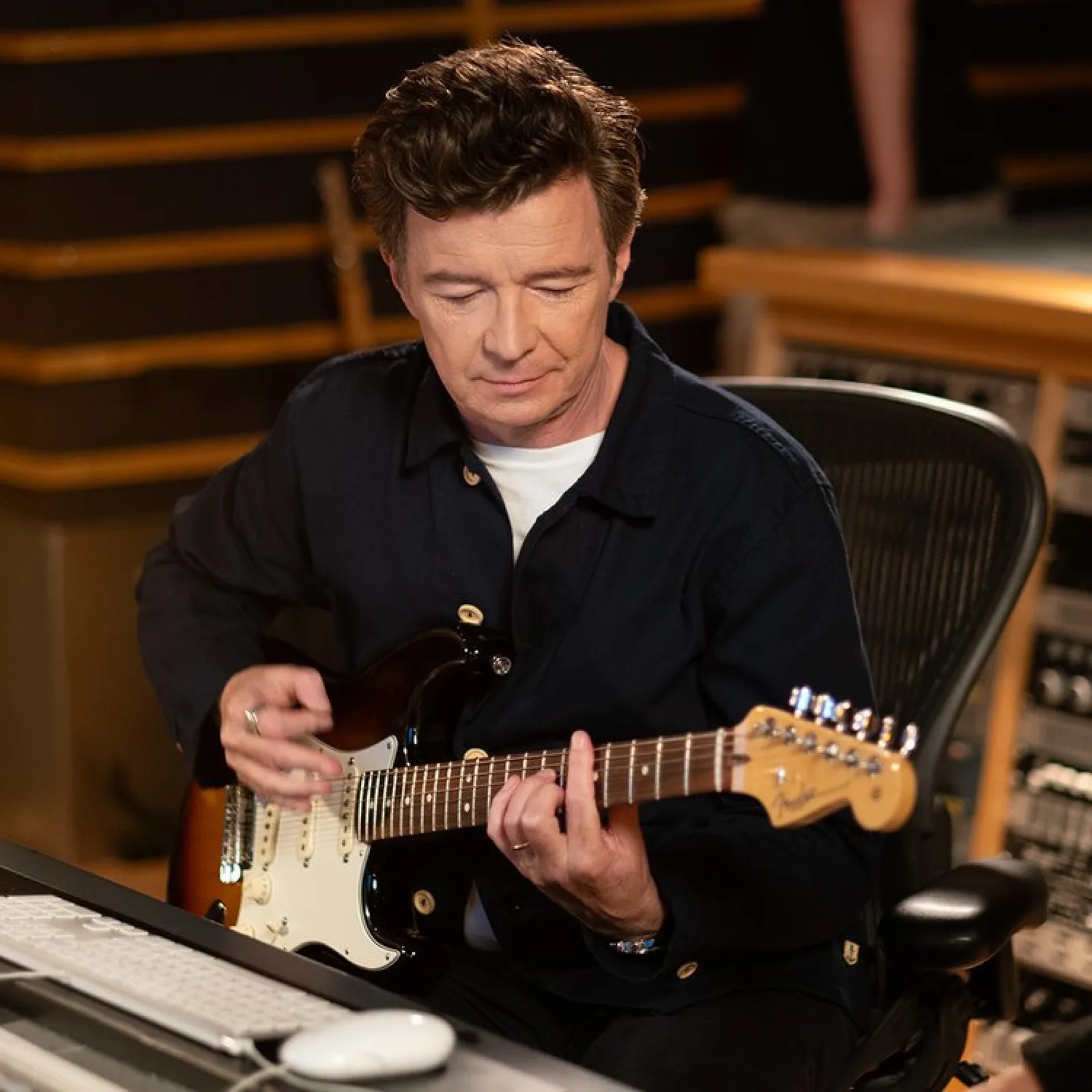 Rick Astley playing guitar in the studio, from Tangerine’s campaign case study.