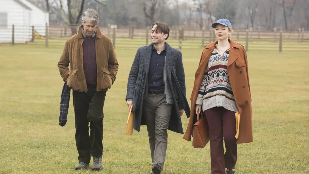 Three Succession characters walk across a field