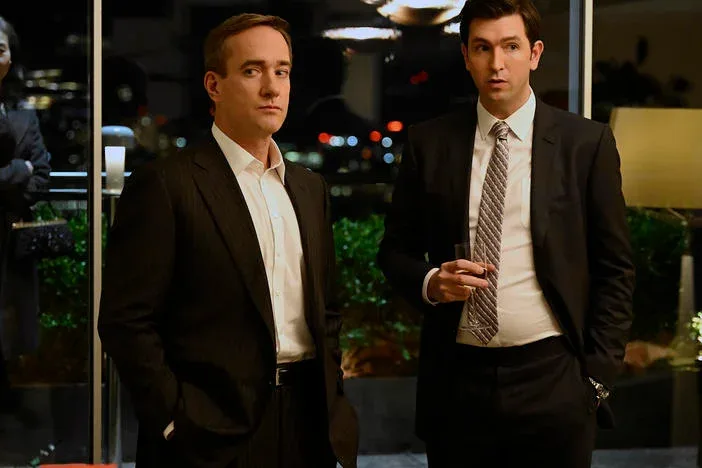 Two Succession characters talk in a hotel lobby