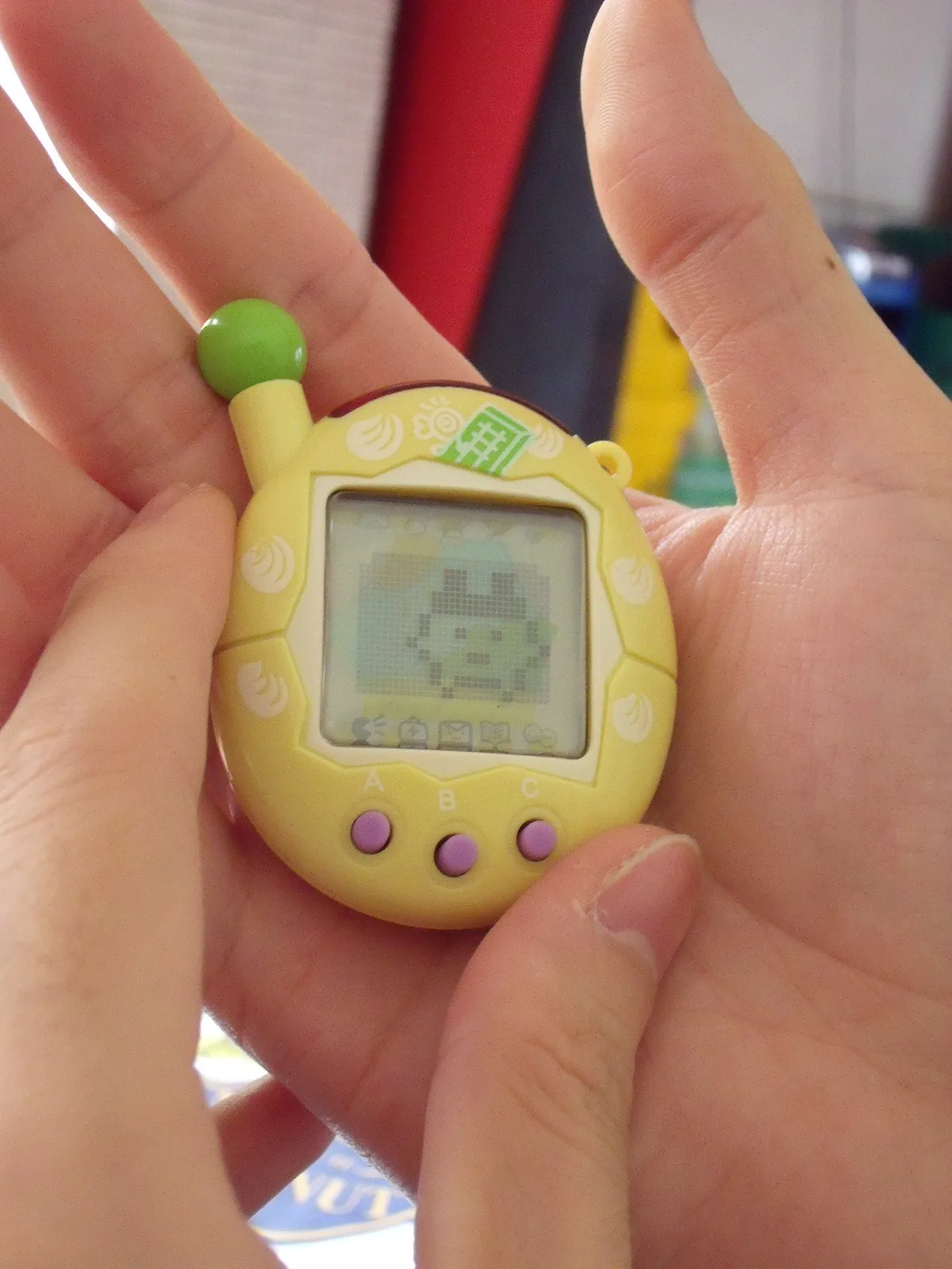 A Tamagotchi device photographed in 2009; public domain.
