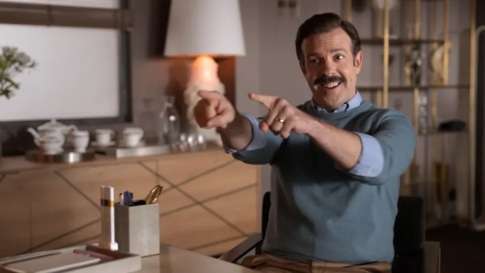 Ted Lasso pointing in his flat