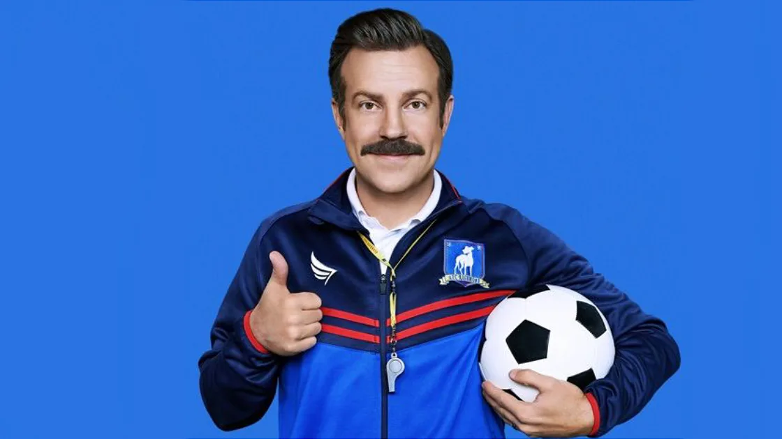 Jason Sudeikis as Ted Lasso with a football
