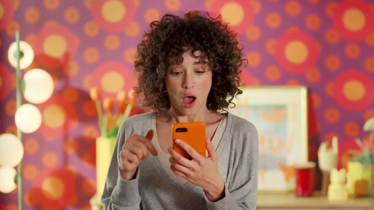 Temu's Big Game ad: a shopper reacts to her phone