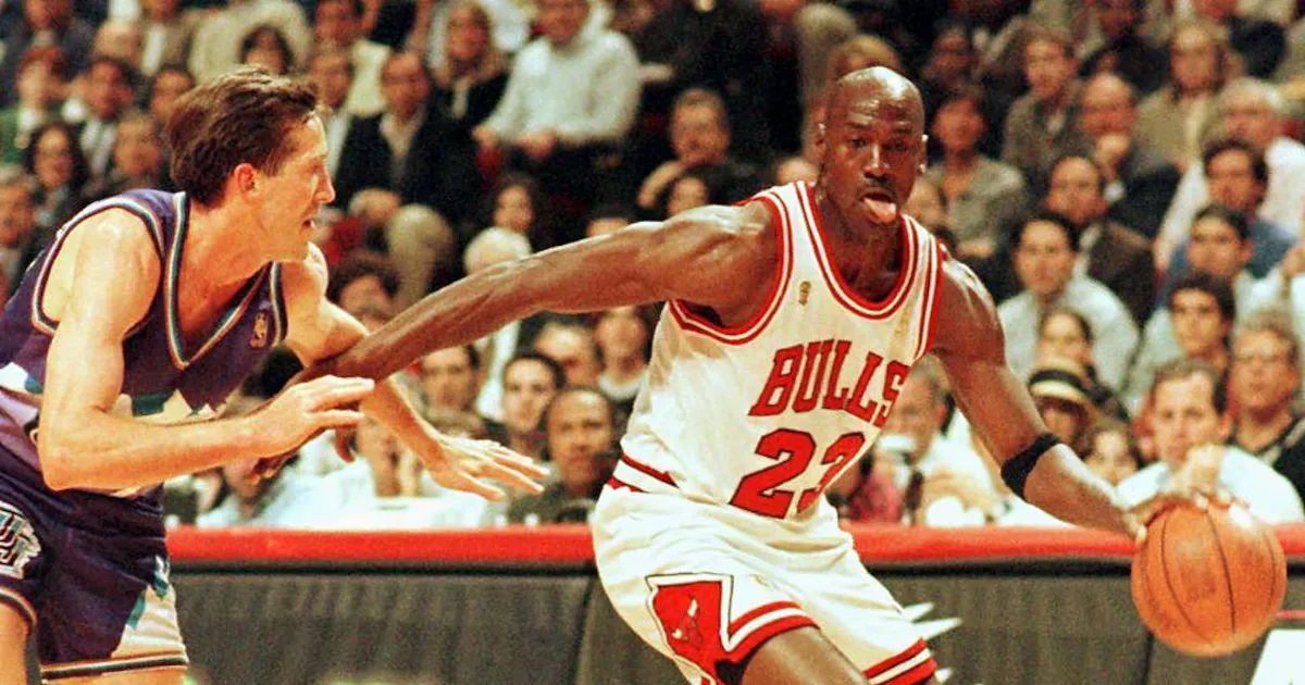 (FILES) In this file photo taken on June 4, 1997 Chicago Bulls player Michael Jordan sticks out his tongue as he goes past Jeff Hornacek of the Utah Jazz during game two of the NBA Finals at the…