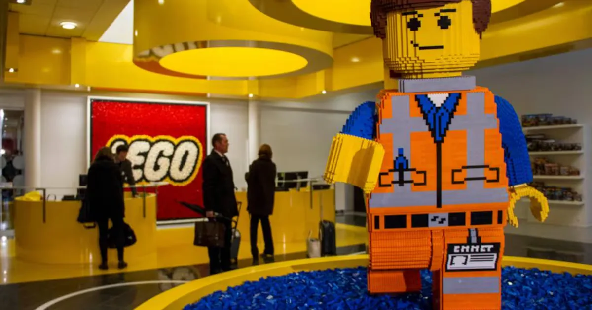 A life-size Lego Emmet figure in a Lego store