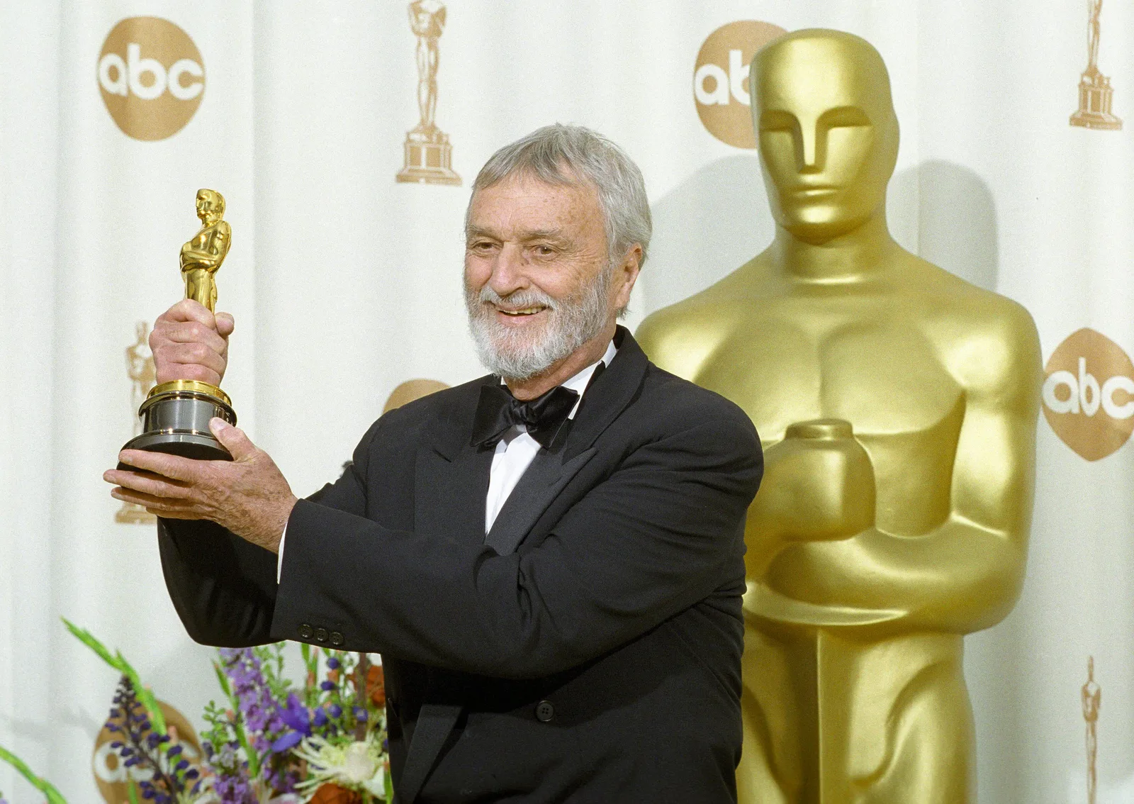 A Matrix crew member holds an Oscar at the 72nd Academy Awards, 2000