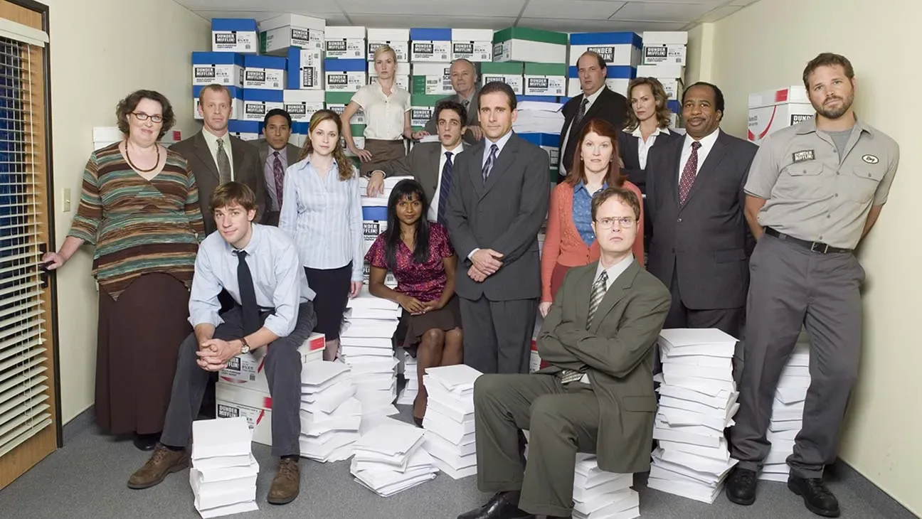 The Office cast posed among paper stacks