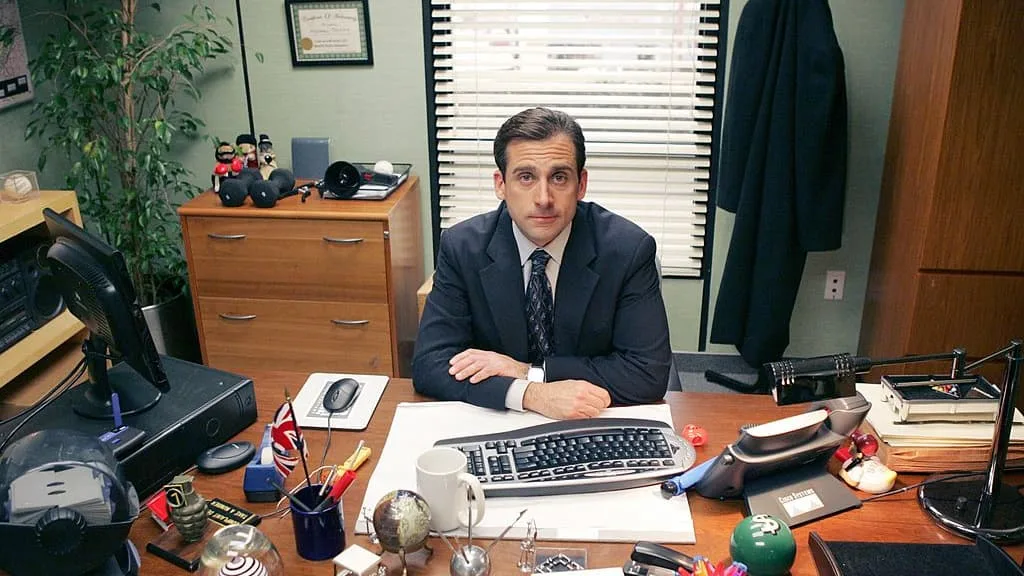 Steve Carell as Michael Scott at his desk