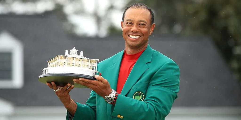 Woods in the green jacket with the Masters trophy