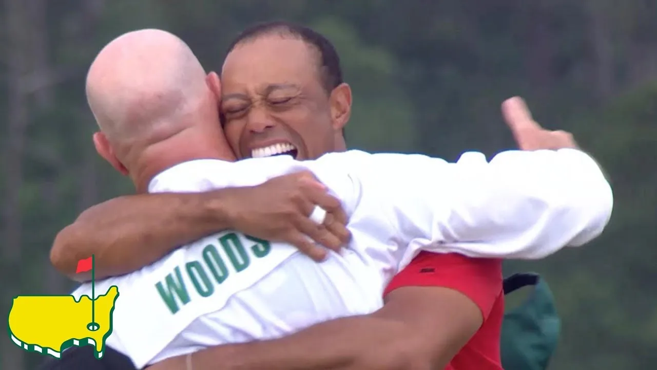 Woods hugs his caddie after the winning putt
