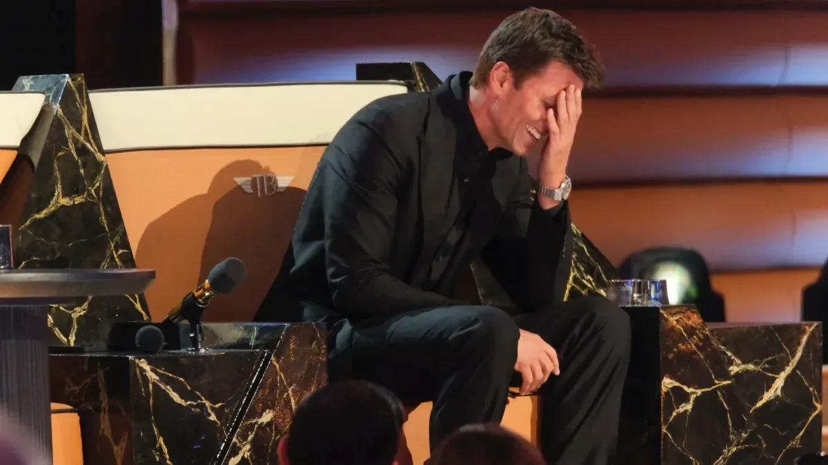 Tom Brady covering his face during the roast