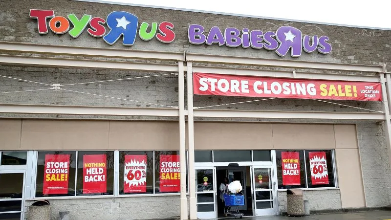 Store closing sale signs at a Toys "R" Us and Babies "R" Us
