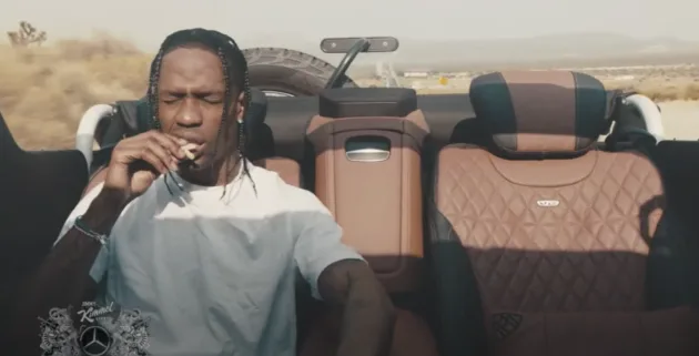 Travis Scott eating fries in the back of a car.