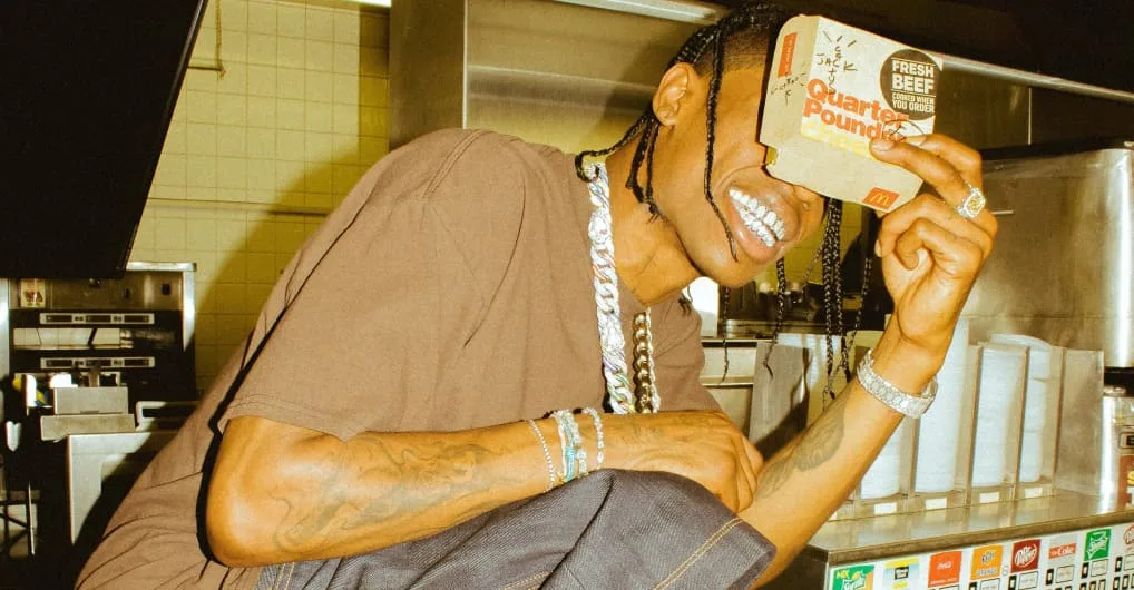 Travis Scott holding a McDonald's carton, from the meal's merch drop.