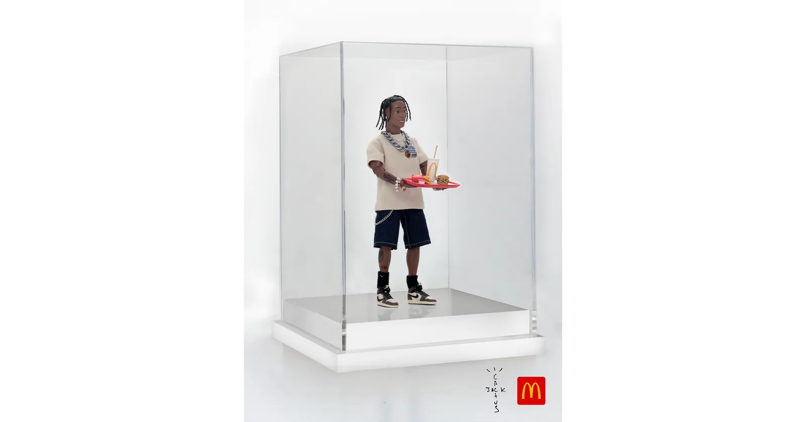 Handcrafted Travis Scott action figure in a glass case, offered in a McDonald's tweet-to-win giveaway.