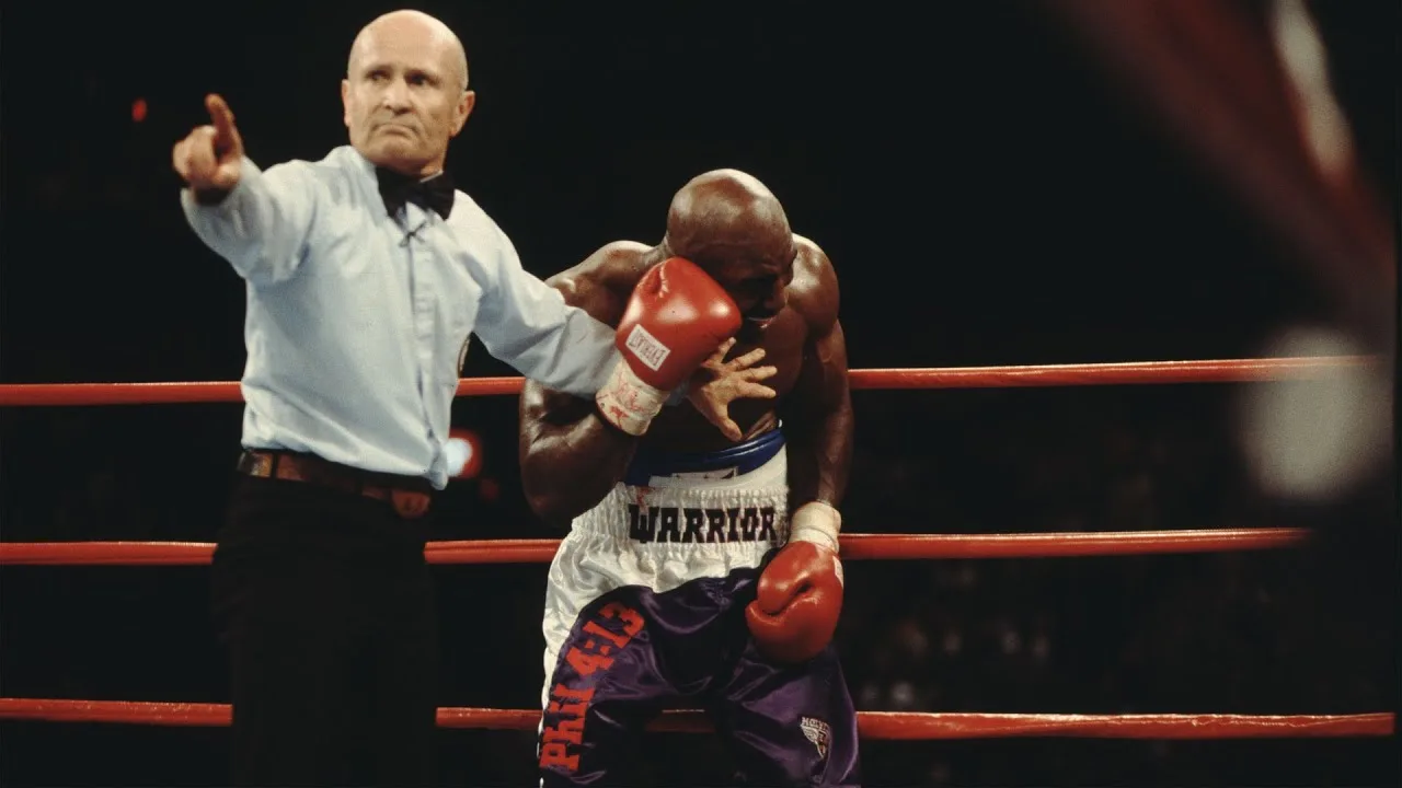 Holyfield holds his ear as Mills Lane waves Tyson off, from Showtime's broadcast