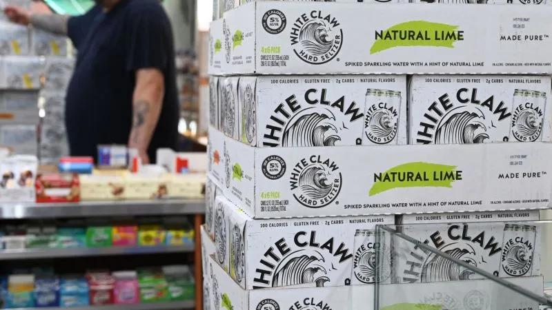 Stacked White Claw cases in a store