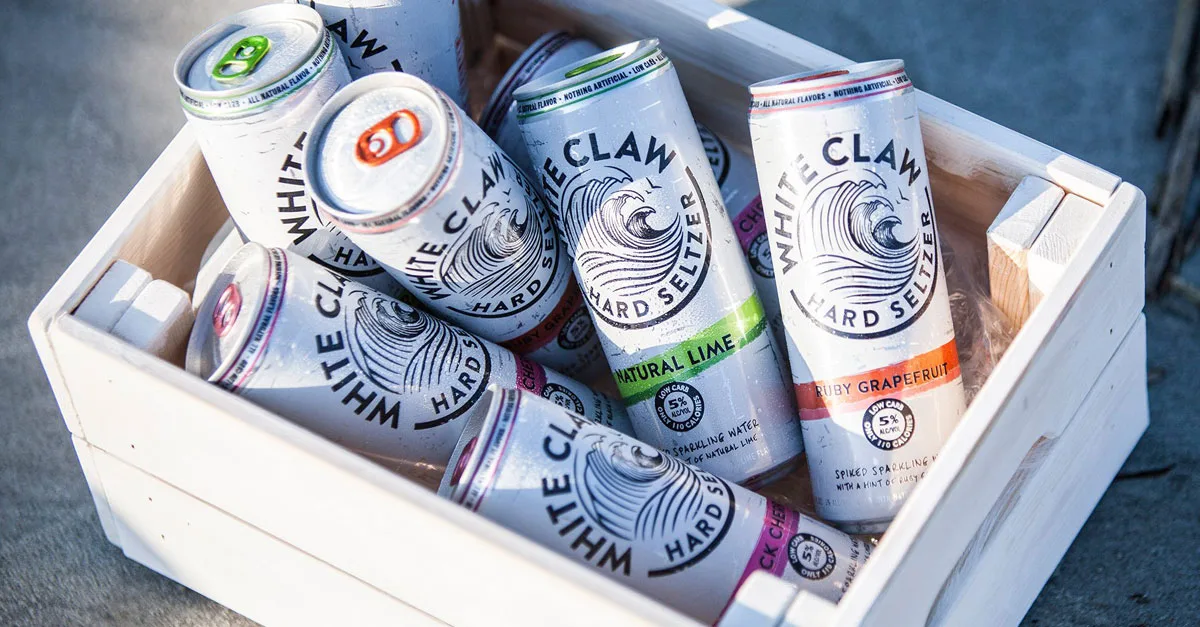 White Claw cans in a wooden crate