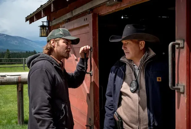 Two ranch hands at a barn door in Yellowstone