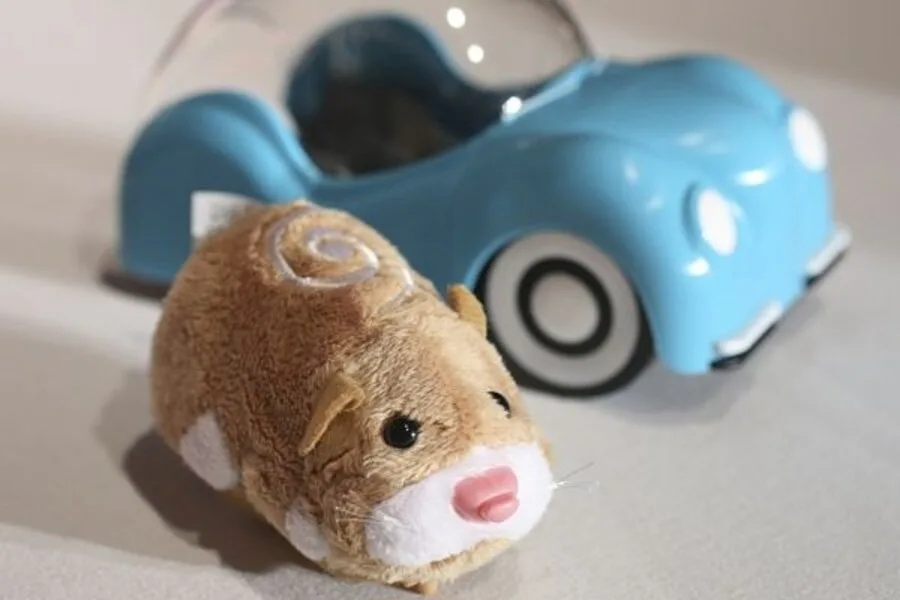 A Zhu Zhu Pets hamster beside its toy car